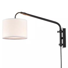 a black wall light with a white shade on the arm and a brown cord attached to it