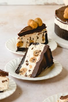 three pieces of chocolate cake on plates with cherries and nuts in the top half