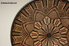 a close up of a basket on a wall with the center circle made out of woven material