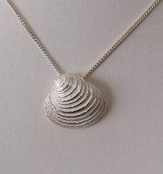 This Silver pendant is handmade featuring a large clam shell.  It is cast in solid Silver from a real shell and because of that has the exact shape, but is much stronger than the natural shell. It will give you a lot of joy and last a lifetime. A Silver curb chain, 40 or 45cm long is INCLUDED. If you require a longer chain please contact me. ALL SILVER PARTS ARE STERLING SILVER 925 MATCHING EARRINGS are available All my jewellery come in a beautiful giftbox or sachet. Large Clam Shell, Clam Shell, Curb Chain, Silver Pendant Necklace, Matching Earrings, Pendant Necklaces, Silver 925, Silver Pendant, Favorite Jewelry