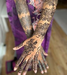 a woman with henna tattoos on her hands