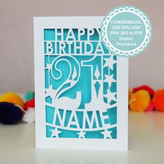 a birthday card with the number twenty two in white and blue, on top of a table