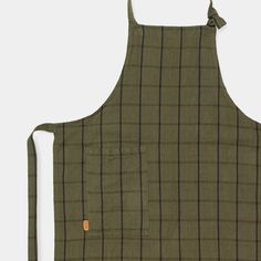 an apron with a pocket on the front, and a brown checkered pattern on the back