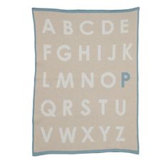 a white and blue alphabet rug with letters on the front, in two different colors