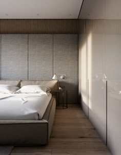 a large bed sitting in the middle of a bedroom next to a tall white wall