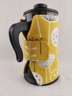 a yellow and white coffee mug with a black handle