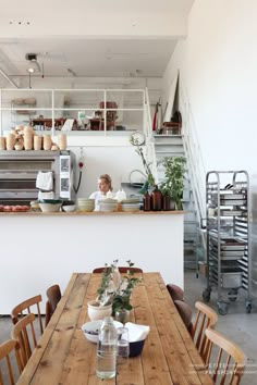 a wooden table sitting in front of a kitchen counter