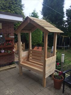 a wooden bench sitting in the middle of a yard