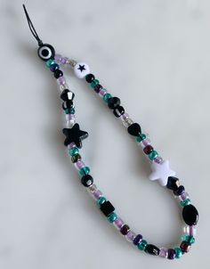 a beaded necklace with black, white and green beads