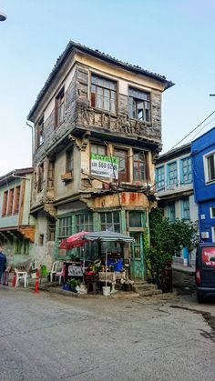 an old wooden building with many windows and balconies on the side of it