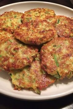 four fritters on a white plate ready to be eaten