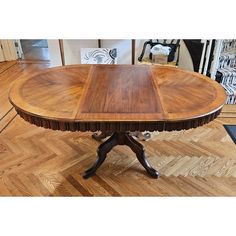 a wooden table sitting on top of a hard wood floor