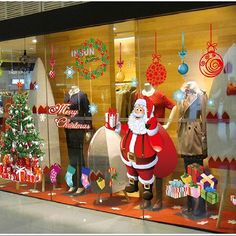 a store window with christmas decorations and santa clause