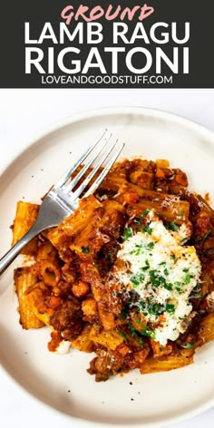 a white plate topped with pasta covered in sauce and parmesan cheese next to a fork