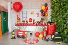 a birthday party with balloons, firetrucks and decorations