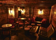 a dimly lit room with several tables and chairs