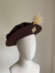 Brown Tudor hat Men's brown Tudor/Henrician bonnet, made to order. This hat features a sturdy buckram brim and comes with the trimming similar to the one seen in the photograph. The hat is made from a lovely textured wool blend, and lined with a lightweight brown cotton. Trim options include brooches, plus coloured feathers, echoing the hats worn by Henry VIII in portraits from the period. Each hat is custom made to your specified head size. I don't keep ready-made stock of these, but I do keep Brown Brimmed Cloche Hat For Kentucky Derby, Brown Brimmed Hat For Kentucky Derby, Brimmed Brown Cloche Hat For Kentucky Derby, Brown Curved Brim Hat For Kentucky Derby, Brown Flat Brim Cloche Hat For Kentucky Derby, Brown Wide Brim Mini Hat For Kentucky Derby, Brown Curved Brim Costume Hat For Winter, Brown Brimmed Mini Hat For Kentucky Derby, Kentucky Derby Brown Brimmed Mini Hat