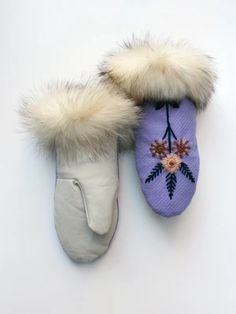 two pairs of slippers with flowers on them, one is white and the other is purple