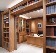 an office with bookshelves and desk in the center, along with other wooden shelves