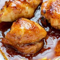 close up of chicken thighs with sauce in a pan