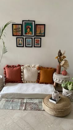 a living room filled with lots of furniture and pictures on the wall above it's couch