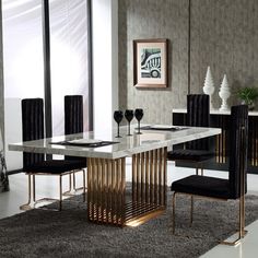 a dining room table with black chairs and a white marble top