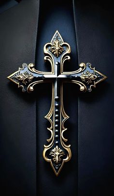 an ornate cross on the side of a black wall