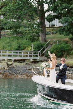 a bride and groom on a boat waving to the crowd at their wedding ceremony in lake geneva