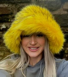 💥My hats are made by me and shipped to you WITHIN 3 days of receiving your order!Welcome to my fluffy shop where absolutely everything is made by me in England!  So because I make everything, any head size can be accommodated for, no worries at all! The standard size will fit heads approx 22- 23.5 inches, but if you want me to make a larger or smaller one, please add a measurement when ordering. Or message me your size.A beautiful super luxury faux fur this stunning bright canary yellow, with black tips. Super Fluffy! Hat fits heads approx 21.5 -23.5 inches but I can make one larger or smaller if you like. The added bonus with my hats is that the polar fleece lining is water resistant, so great if caught in a downpour! All handmade by me in Lancashire! Yellow Festival Hat, Cheap Yellow Novelty Hat, Trendy Yellow Festival Hat, Fun Yellow Hat For Festivals, Fun Yellow Hat For Festival, Fun Yellow Festival Hat, Yellow Brimmed Fun Hat, Fun Yellow Brimmed Hat, Winter Festival Beanie Mini Hat