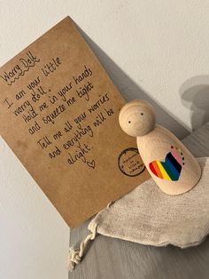 a wooden toy with a note attached to it