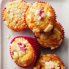 several muffins on a plate with crumbs all over them