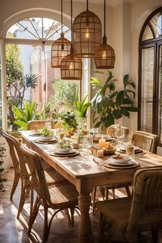 a dining room table set with plates and place settings in front of an arched window