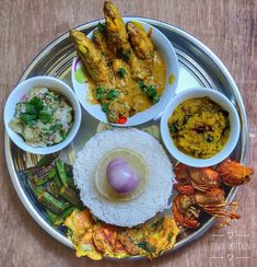 a plate with different types of food on top of it, including rice and shrimp