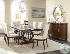 a dining room table with white chairs around it