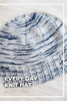 a blue and white knitted hat with the words, every day knit hat