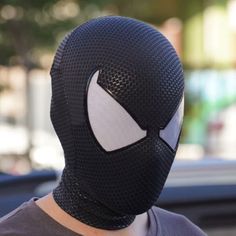 a person wearing a spider man mask on their head