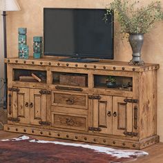 a large wooden entertainment center with drawers and a flat screen tv mounted on it's side