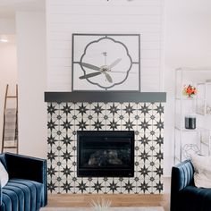 a living room filled with furniture and a fire place in front of a wall mounted clock