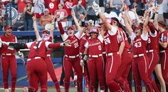 the women's softball team is celebrating their win in front of an excited crowd