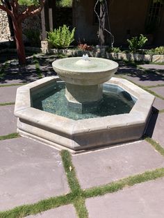 an outdoor fountain in the middle of a courtyard