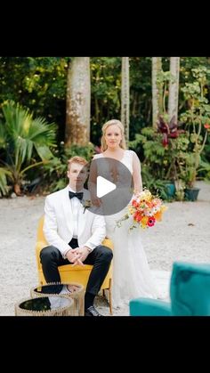 a man and woman sitting next to each other on a yellow chair in front of trees