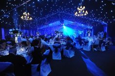 a room filled with lots of tables covered in blue lights