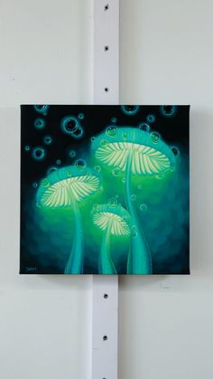 a painting hanging on the side of a white wall with blue and green colors in it