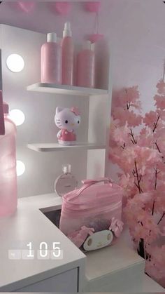 a bathroom with pink flowers and hello kitty decor on the wall, toiletries and other items