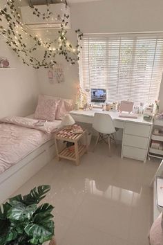 a bedroom with white furniture and pink decor