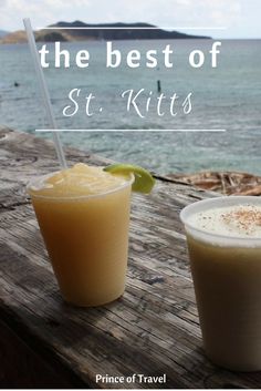 two drinks sitting on top of a wooden table next to the ocean with text overlay that reads, the best of st kitts prince of travel