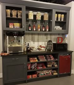 a coffee bar with lots of food and drinks on it's shelves in a room