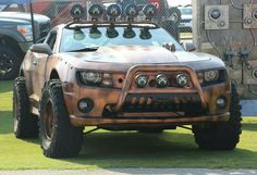 a large truck with some big wheels on it's front bumpers and lights