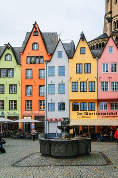 many colorful buildings with people sitting around them