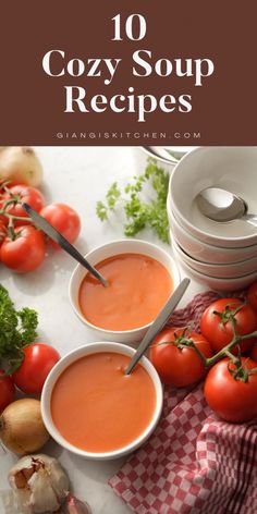 several different types of soups on a table with tomatoes, garlic and parsley